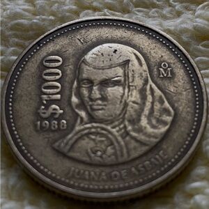 A rare Maxico 1988 $1000 Posos Silver Coin with Historical Figure Design.